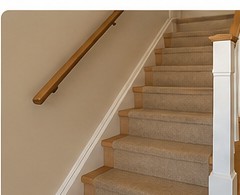 Secure wooden handrail on carpeted stairs